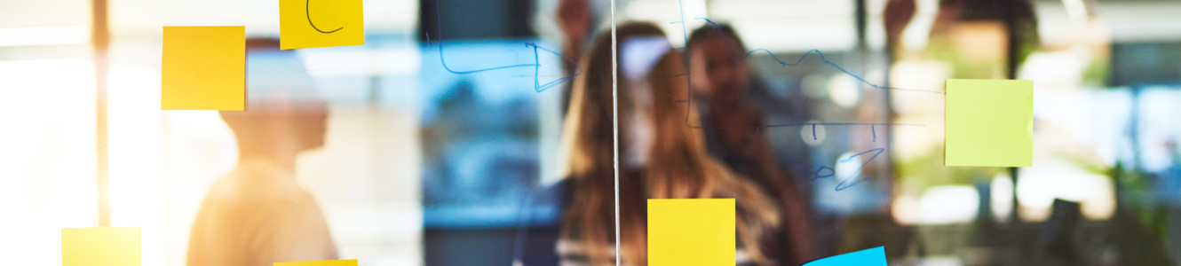 Sticky notes on a glass wall at a small business